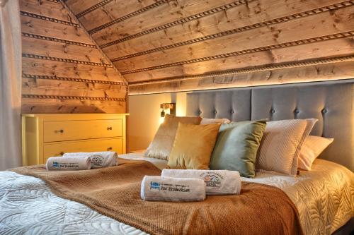 a bedroom with a bed with two towels on it at Pod Źródełkiem in Cisna