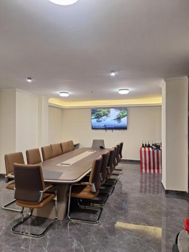 a conference room with a long table and chairs at Point Central Hotel in Addis Ababa