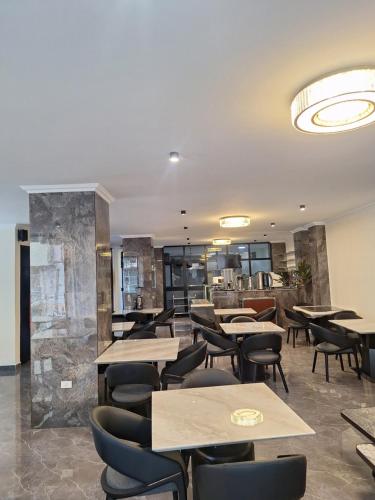 a restaurant with tables and chairs in a room at Point Central Hotel in Addis Ababa