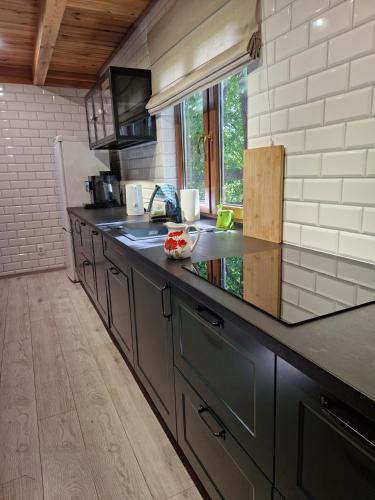a kitchen with a large counter top in a room at Dom w Zaciszu Drzew Szkotowo in Szkotowo