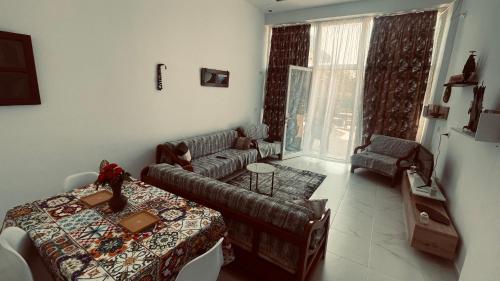 a living room with a couch and a table at Poga Apartment in Durrës