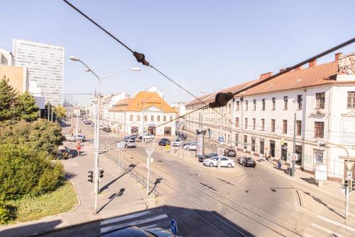 a view of a city street with cars and buildings at Blue Lotus Apartments in Bratislava