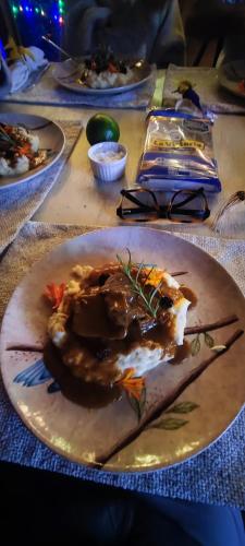 a table with plates of food on a table at El Color de Mis Rêves in Villamaría