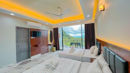 a hotel room with two beds and a balcony at Cloudy Inn Resort in Bāndarban
