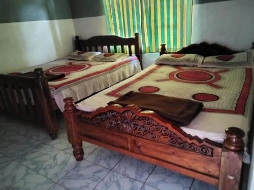 Ένα ή περισσότερα κρεβάτια σε δωμάτιο στο Lakshmi Vasan Homestay