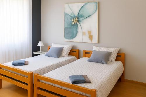 two beds sitting next to each other in a room at Apartman 993 in Pale