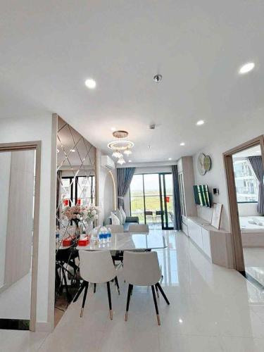 a dining room and living room with a table and chairs at Thương Apartment 2 in Thôn Văn Dương