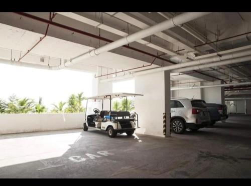 a golf cart parked in a parking garage at Apartment Beachfront Phan Thiet-Ocean Vista-C315 in Ấp Ngọc Hải