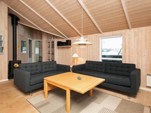 a living room with two couches and a coffee table at Modern Beach Retreat - By Traum Ferienwohnungen in Løkken