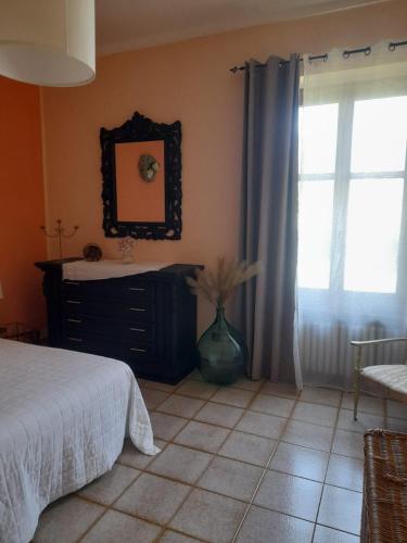 a bedroom with a bed and a mirror and a window at Casa La V G in Almese