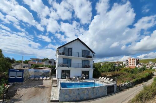 a villa with a swimming pool and a house at Villa Luca in Krimovice