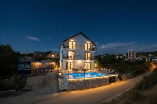a house with a swimming pool at night at Villa Luca in Krimovice