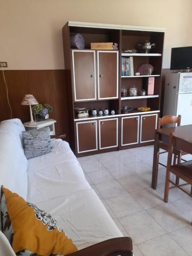 a living room with a white couch and a kitchen at Casa La V G in Almese