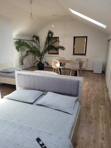 a bedroom with a bed and a table and chairs at Vila Vati - Arena Pitesti in Piteşti