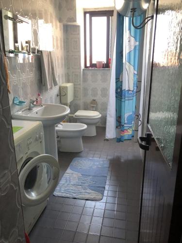 a bathroom with two toilets and a sink and a shower at Grandmas Apartment in Shkodër
