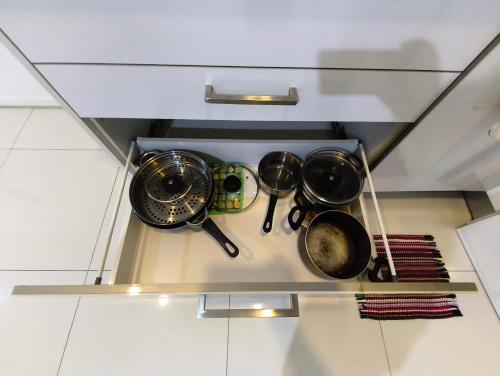 a group of pots and pans sitting on top of a stove at Summer Suites KLCC by CozyNest in Kuala Lumpur