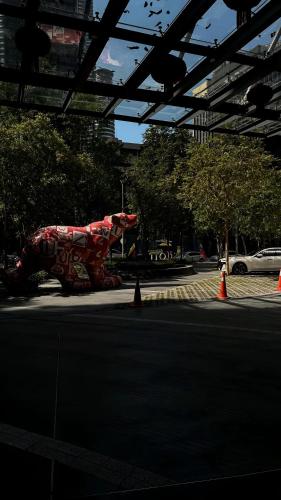 a statue of a dog on a street with orange cones at Premier Suites Twin Towers at Star Residences in Kuala Lumpur