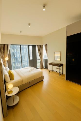 a bedroom with a bed and a desk and a television at Premier Suites Twin Towers at Star Residences in Kuala Lumpur