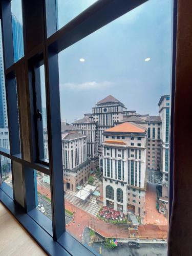 a view of a city from a window at Premier Suites Twin Towers at Star Residences in Kuala Lumpur