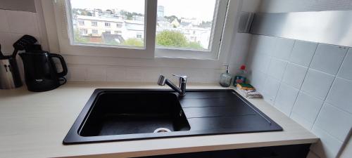 a kitchen counter with a sink and a window at Escale à brest - Spacieux - 3 chambres - Parking privé - Ideal Familles & Pros in Brest