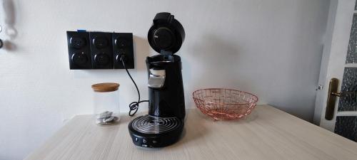 a black coffee maker sitting on top of a table at Escale à brest - Spacieux - 3 chambres - Parking privé - Ideal Familles & Pros in Brest