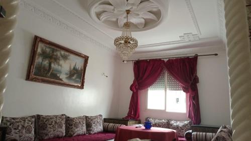 a living room with a couch and a window at Appartement Familial près Aéroport Tanger in Tangier