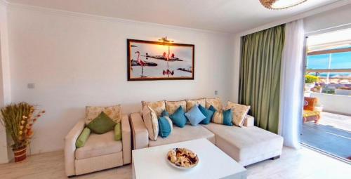 a living room with a couch and a table at Boutique Citadel in Eforie Nord