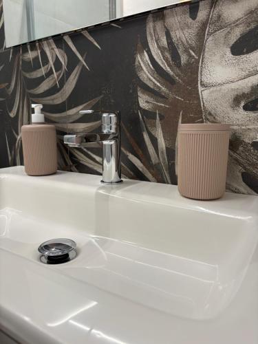 a bathroom sink with two candles on top of it at Appartamento Leon in Roseto degli Abruzzi