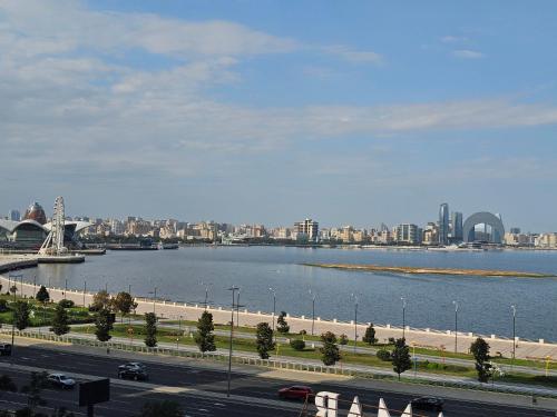 a view of a city with a river and a bridge at Crown Suites in Baku