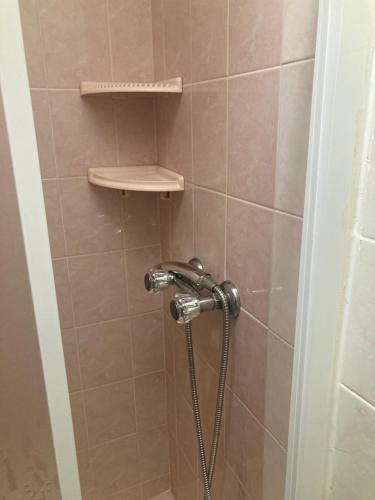 a shower with a shower head in a bathroom at Rolo House in Nazaré