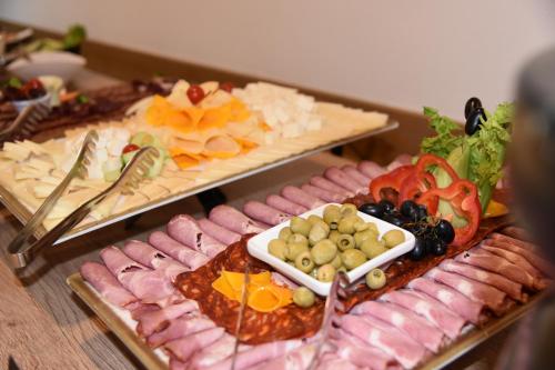 a table topped with different types of food at Aparthotel Vucko in Jahorina