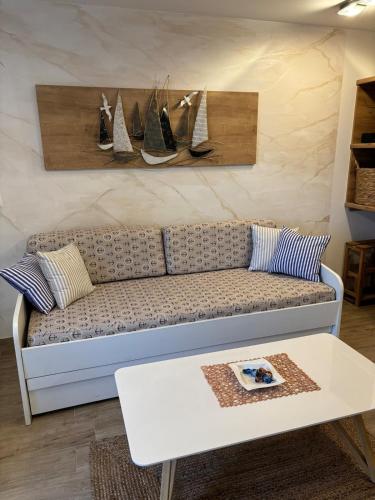a living room with a couch and a table at Apartman Sidro in Rijeka