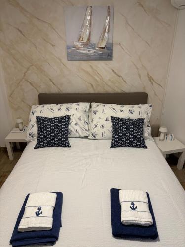 a bedroom with a bed with towels on it at Apartman Sidro in Rijeka