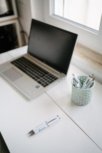 a laptop computer sitting on a desk with a cup of pens at Casa Cleo al Mare con Free WiFi Netflix AC in Carrao