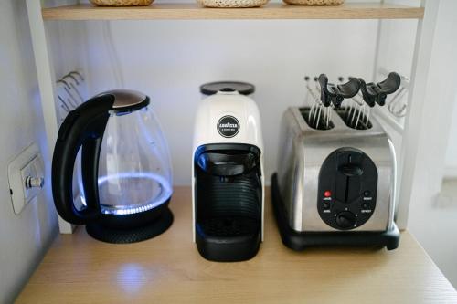 a shelf with various appliances on a kitchen counter at Casa Cleo al Mare con Free WiFi Netflix AC in Carrao