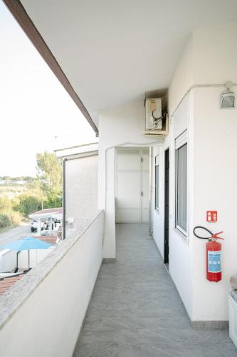 a hallway of a white house with a pool at Casa Cleo al Mare con Free WiFi Netflix AC in Carrao