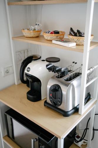 a toaster sitting on a shelf in a kitchen at Casa Cleo al Mare con Free WiFi Netflix AC in Carrao