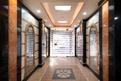 a walk in wine cellar with a row of wine racks at Elyasmene in Qena