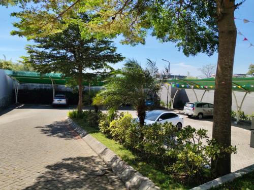 a parking lot with cars parked in front of a building at Reindhita Bliss Villa Batu in Batu