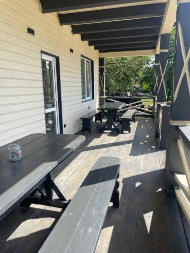 a picnic table and benches on a patio at Black & White House in Mykulychyn