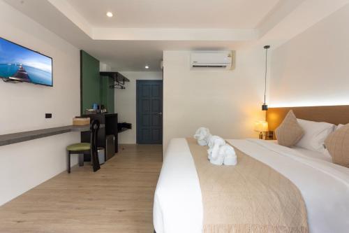 a hotel room with a bed and a desk at XL PATONG Hotel in Patong Beach