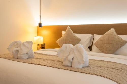 a hotel room with towels on a bed at XL PATONG Hotel in Patong Beach