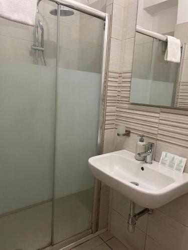 a bathroom with a sink and a shower at St Suite Venice in Venice