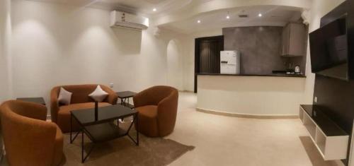 a living room with two chairs and a table at شقة فندقية فاخرة in Taif