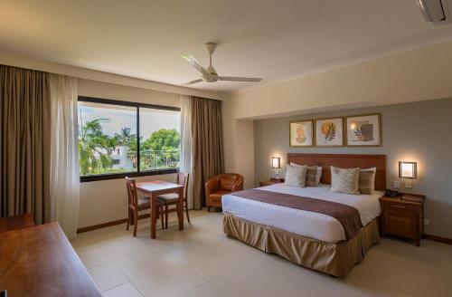 a hotel room with a bed and a window at Sea Cliff Court Hotel & Luxury Apartments in Dar es Salaam
