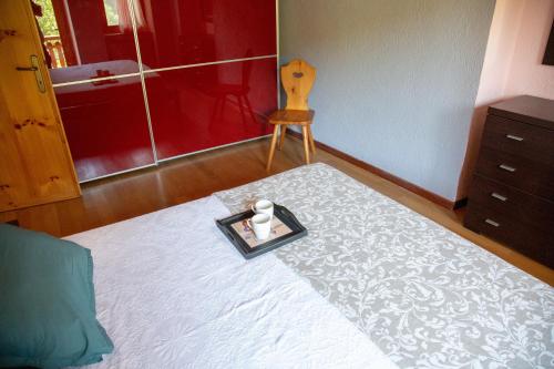 a bedroom with a bed with a tray with candles on it at 123 la casa nel bosco in Curino
