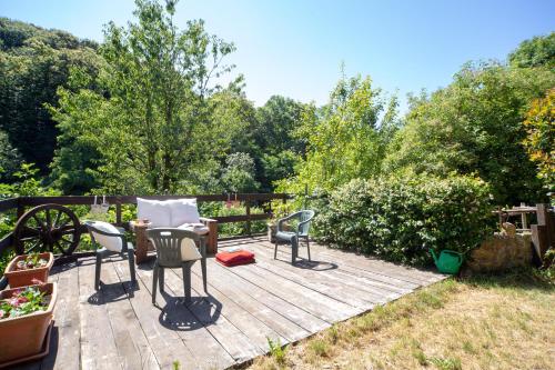 a patio with chairs and a table in a garden at 123 la casa nel bosco in Curino