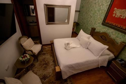 a small room with a bed and a chair at Salamina Highs in Salamina