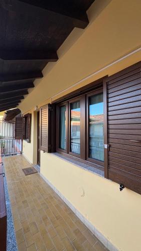 a house with wooden doors and windows at La casetta in Cesano Maderno