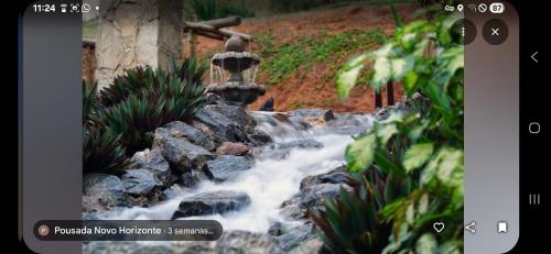 a picture of a water fountain in a garden at Chalés Novo Horizonte in Natividade do Carangola